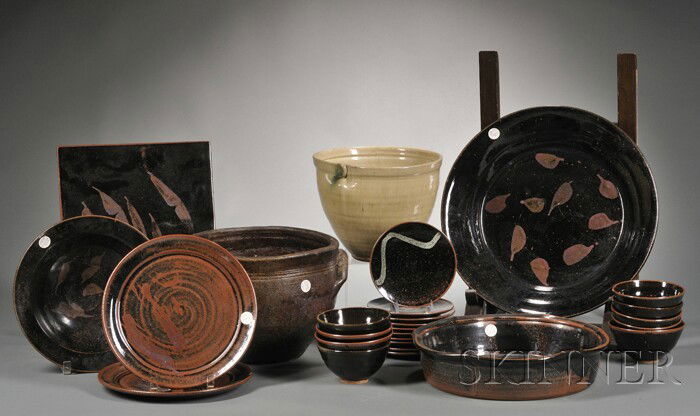 Twenty-seven Pieces of Functional Pottery Glazed e: Twenty-seven Pieces of Functional Pottery Glazed earthenware Fourth quarter 20th century Large stoneware double-handled vessel, decorated serving bowl, circular platter, deep lobed serving dish, and r