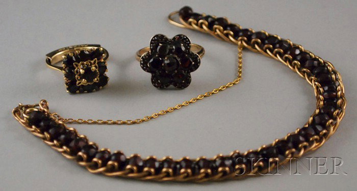 Three Garnet Items, an 18kt gold and garnet ring, : Three Garnet Items, an 18kt gold and garnet ring, a gold and garnet flowerhead ring, and a gold-filled garnet bracelet, rings size 5 1/2 and 7, respectively, bracelet lg. 7 1/2 in.