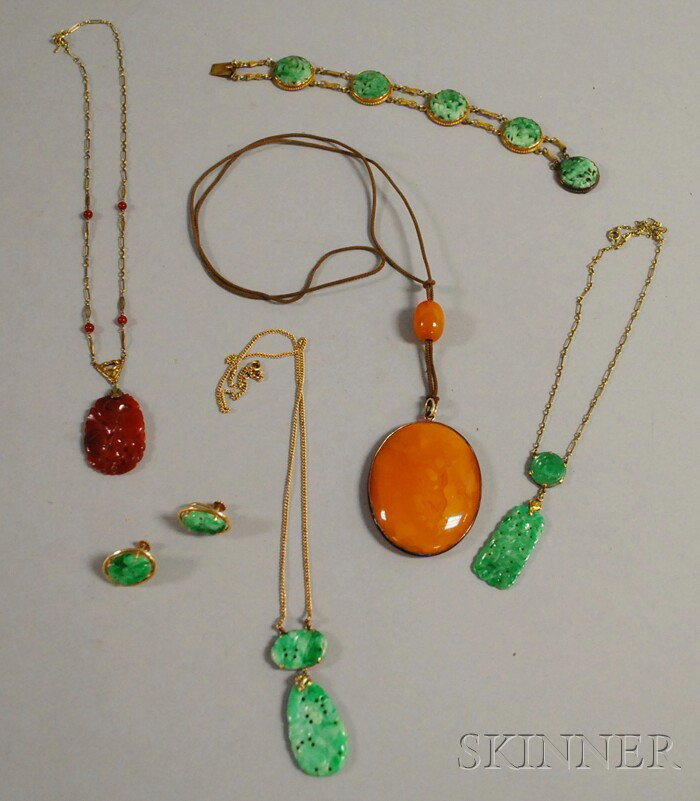 Group of Hardstone Jewelry, a large amber pendant : Group of Hardstone Jewelry, a large amber pendant necklace, a 14kt gold and carved jade necklace, a 14kt gold and carved carnelian necklace, a 14kt gold and jade suite, and a jade bracelet.