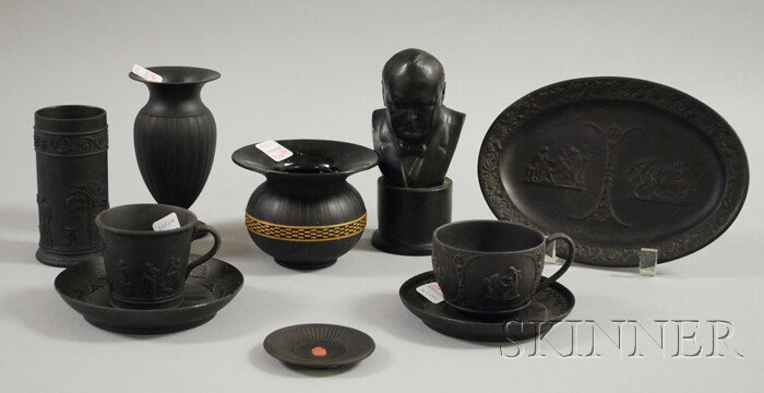 Ten Wedgwood Black Basalt Items, two cups and sauc: Ten Wedgwood Black Basalt Items, two cups and saucers, a bust of Churchill, a spill vase, spittoon, cup plate, oval plaque, and a vase.