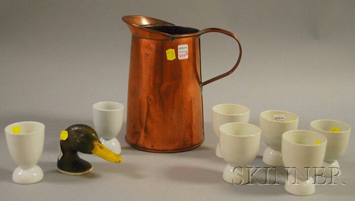 Seven Ceramic Egg Cups, a Copper Pitcher, and a Ru: Seven Ceramic Egg Cups, a Copper Pitcher, and a Rubal Painted Cast Metal Duck Bottle Opener.