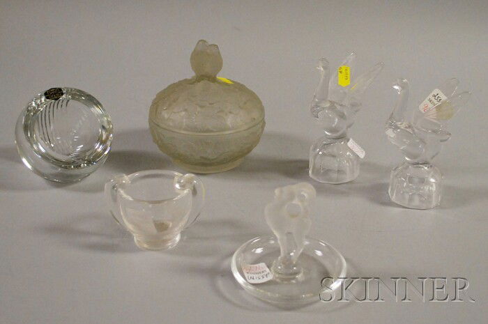 Six Assorted Colorless Art Glass Table Items, a Sa: Six Assorted Colorless Art Glass Table Items, a Saint Louis crystal ashtray, a pair of swan figurals, a small Steuben bowl, a Lalique figural ring dish, and a Lalique-style covered bowl.