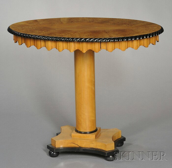 Swedish Biedermeier-style Birch and Part-ebonized: Swedish Biedermeier-style Birch and Part-ebonized Table, 19th century, the oval top with inlay and molded edges over fluted frieze with single drawer and scalloped edges, the columnar support on quadr