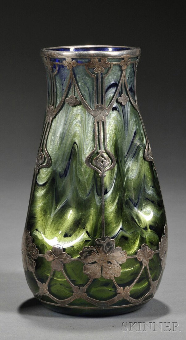 Art Nouveau Silver Overlay Iridescent Glass Vase,: Art Nouveau Silver Overlay Iridescent Glass Vase, cobalt blue glass with pale blue and green iridescent draped design and pinched body, overlaid with silver floral motifs, ht. 9 1/4 in.