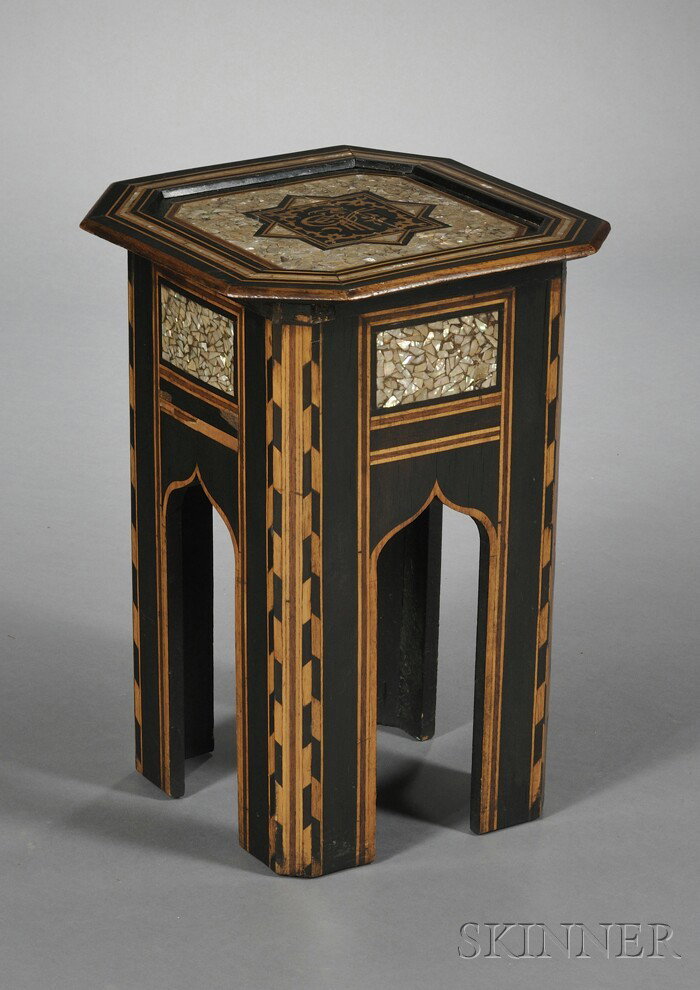 Moorish-style Ebonized Wood and Mother-of-pearl In: Moorish-style Ebonized Wood and Mother-of-pearl Inlaid Occasional Table, octagonal top with recessed center and central medallion displaying a faux-Arabic character, on four legs with brackets modeled
