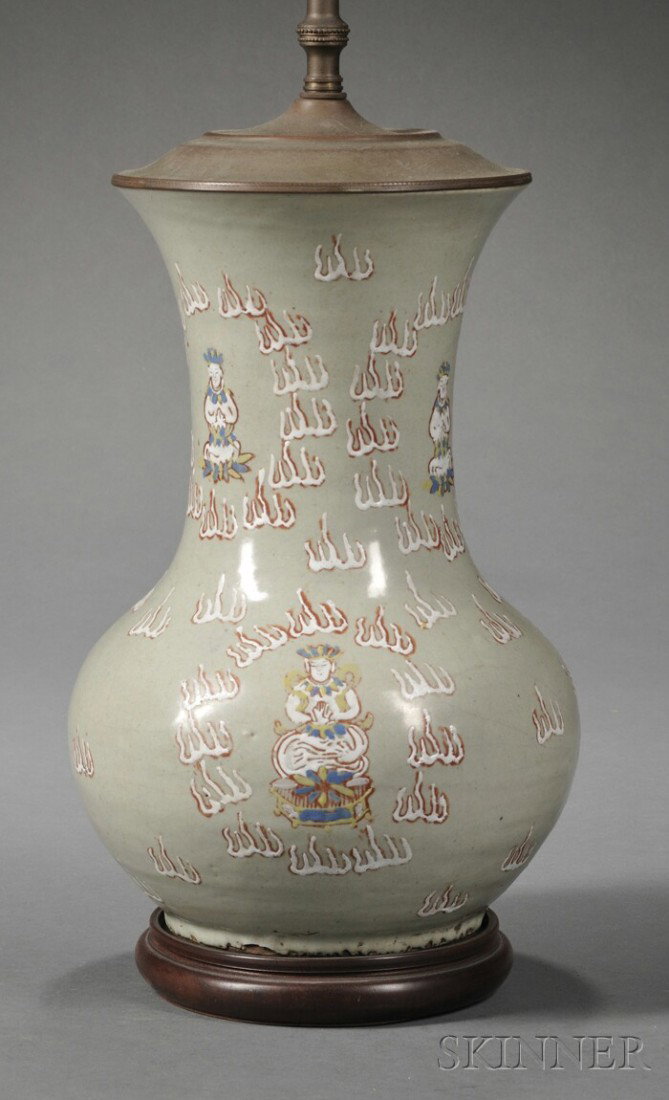 Asian Celadon-glazed Earthenware Vase Lamp Base, w: Asian Celadon-glazed Earthenware Vase Lamp Base, with slip decoration of seated Buddhas within stylized flames, on wooden base, electrified and drilled, vase ht. 12 1/2 in.