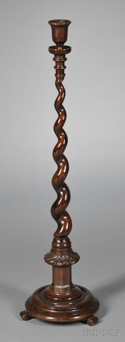 English Mahogany Floor Candlestick, the urn-form p: English Mahogany Floor Candlestick, the urn-form pricket with drip tray and graduated rings joining spiraled stem ending in a foliate wreath adorning octagonal plateau, on circular stepped base with t