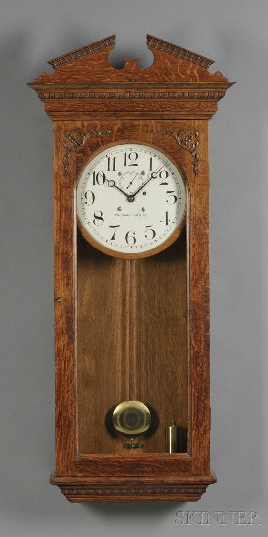 Waltham Oak Wall Regulator No. 33, Waltham Clock C: Waltham Oak Wall Regulator No. 33, Waltham Clock Company, c. 1900, with pitched pediment crest, full length glazed door, 12-in. painted zinc dial with Arabic numerals and marked Waltham Clock Co., eig