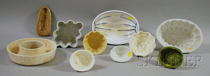 Ten Ceramic Culinary Molds, including a maiden, f: Ten Ceramic Culinary Molds, including a maiden, floral, grapes, pinwheel, seashell, wreath, a design, and a German melon-form.