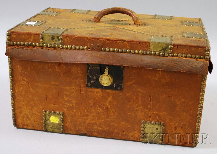 Brass-mounted Leather-clad Trunk, Boston, 1830-36: Brass-mounted Leather-clad Trunk, Boston, 1830-36, the lid mounted with oval plaque engraved "Boston Wharf Company," the interior clad with blue and white polka dot wallpaper, and paper label "James B