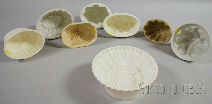 Eight Ceramic Culinary Molds, including grapes, a: Eight Ceramic Culinary Molds, including grapes, a German sheaf of wheat, a floral, two design, a seashell, sunflower, and one with scrolls.