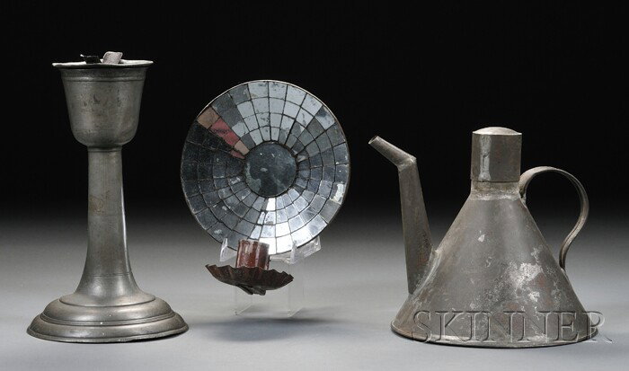 Three Early Lighting Devices, 19th century, a red-: Three Early Lighting Devices, 19th century, a red-painted tin mirrored wall sconce with round reflector with radiating mirrored segments, and round crimped candle cup; a pewter standing wick support l