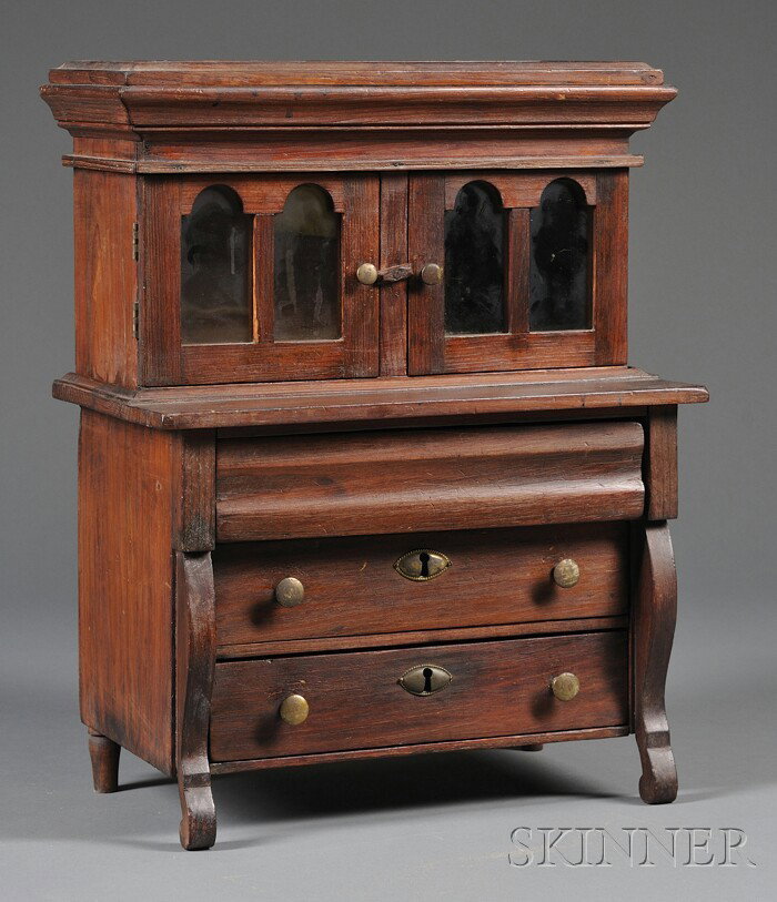 Miniature Empire-style Pine Secretary, America, ea: Miniature Empire-style Pine Secretary, America, early 19th century, two pieces, top with molded cornice on compartment with hinged top over tombstone-shaped glazed doors, set on a dovetail-constructed
