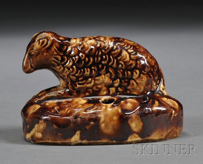 Rockingham Glazed Sheep-form Inkwell/Pen Holder, A: Rockingham Glazed Sheep-form Inkwell/Pen Holder, America, 19th century, molded reclining sheep figure on an oval base, (chips), ht. 3, dia. 4 1/4 in.