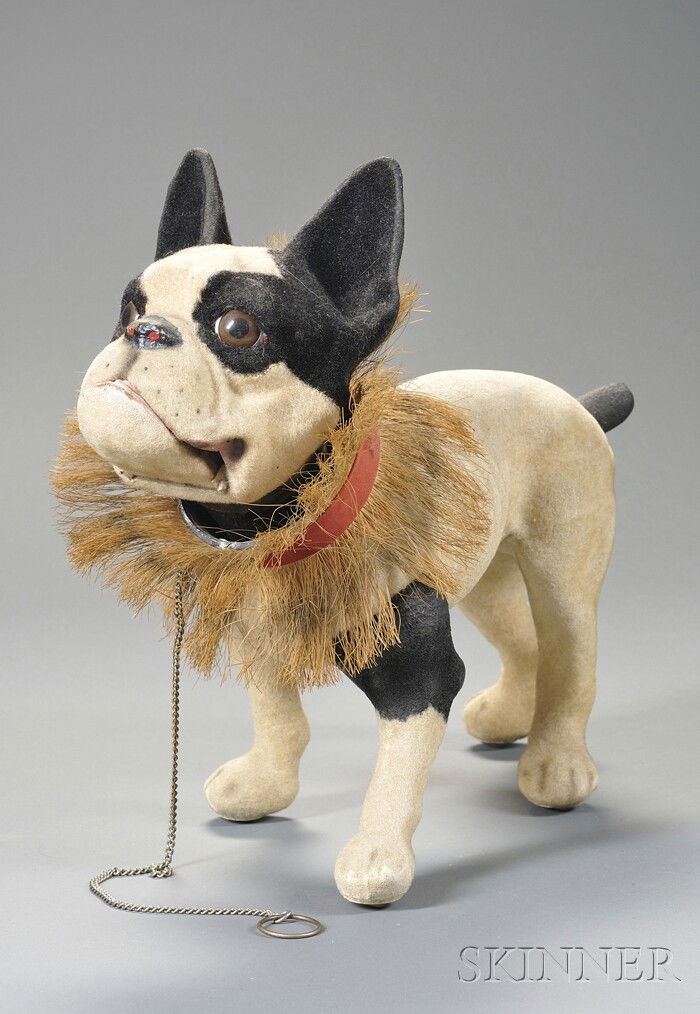 Flocked Papier-mache French Bulldog Pull-toy, earl: Flocked Papier-mache French Bulldog Pull-toy, early 20th century, nodding head with glass eyes, the chain leash pull opens hinged mouth and dog barks, fringed collar, rolls on wood casters, ht. 15, lg