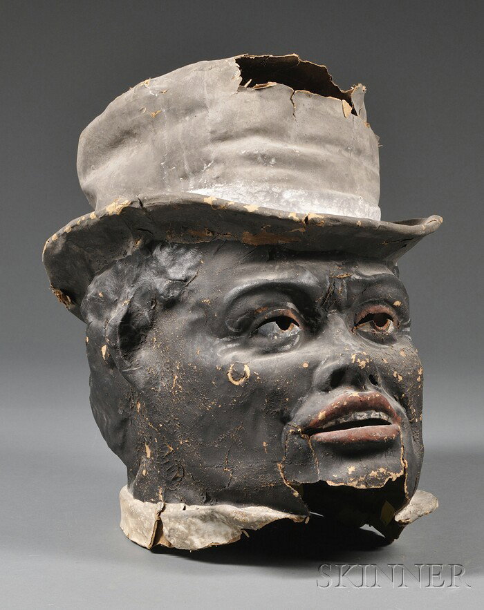 Painted Papier-mache Mask of a Black Man's Head We: Painted Papier-mache Mask of a Black Man's Head Wearing a Top Hat, late 19th/early 20th century, (losses, tears), ht. 16 in.