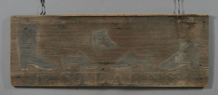 Relief-carved and Painted Wood Bootmaker's Trade S: Relief-carved and Painted Wood Bootmaker's Trade Sign, America, early 19th century, applied molding across the top of wide pine panel with two relief-carved boots flanking three shoes, above the inscr