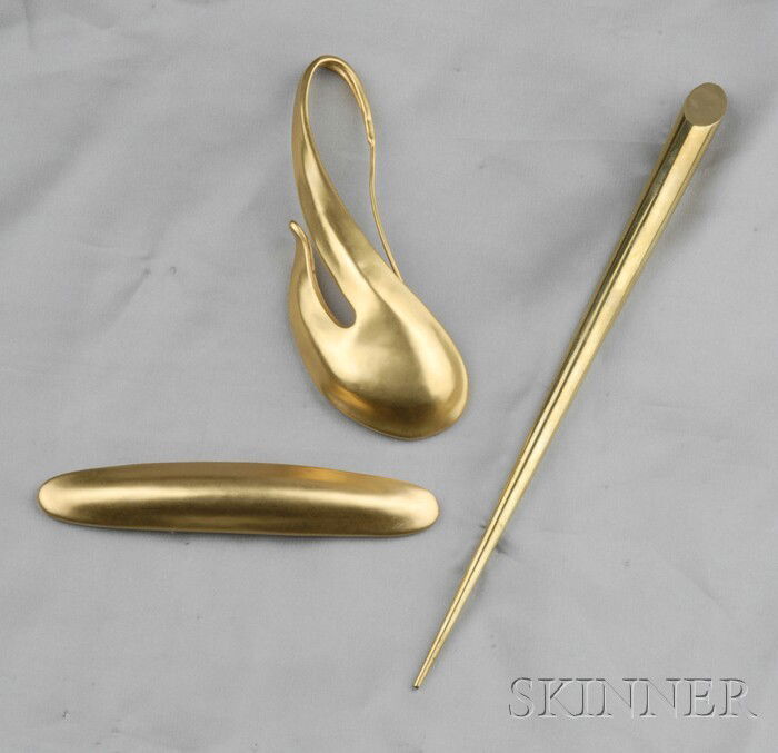 Three Brooches, Robert Lee Morris, an abstract for: Three Brooches, Robert Lee Morris, an abstract form, an elongated convex dome, and a tusk pin, all in gold plate, lg. 4 5/8, 4 1/2, 8 in. Note: According to the consignor, the lot pictured was used in