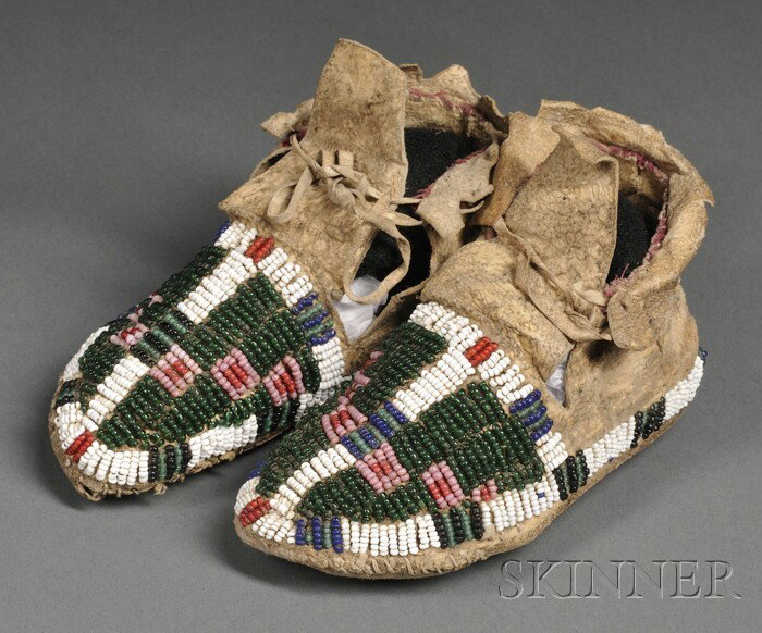 Central Plains Beaded Hide Child's Moccasins, Lako: Central Plains Beaded Hide Child's Moccasins, Lakota, c. late 19th century, with rawhide soles and beaded on the top with multicolored geometric designs, lg. 5 in.