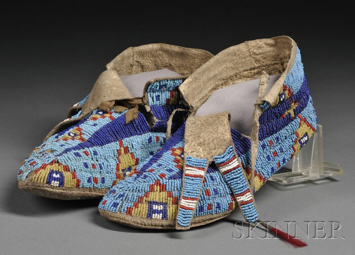Central Plains Beaded Hide Moccasins, Lakota, c. l: Central Plains Beaded Hide Moccasins, Lakota, c. late 19th century, with hard soles, bifurcated beaded tongues, the tops fully beaded with multicolored geometric designs, (bead loss), lg. 10 in. Prove