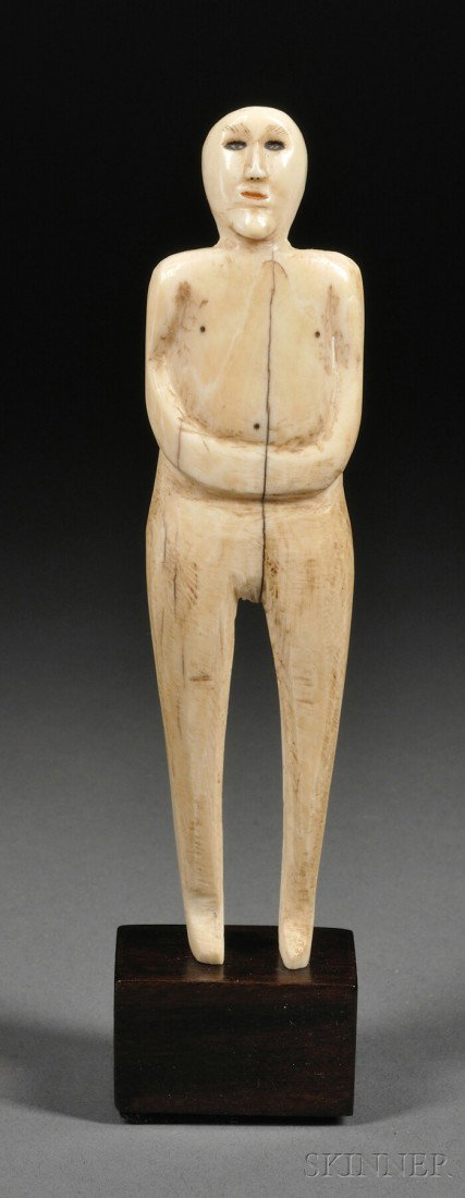 Eskimo Carved Ivory Figure, c. 1900, depicted stan: Eskimo Carved Ivory Figure, c. 1900, depicted standing and gazing up, traces of pigment in eyes and mouth, ht. 5 1/8 in.