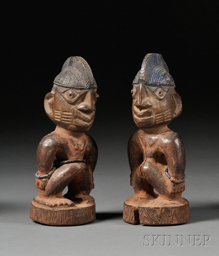 Two African Carved Wood Ibejis, Yoruba, stylized w: Two African Carved Wood Ibejis, Yoruba, stylized women with large heads and detailed coiffures, ht. 9 in.