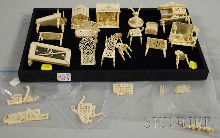 Seventeen Pieces of Miniature Carved Ivory Europea: Seventeen Pieces of Miniature Carved Ivory European-style Furniture, Asia, 19th century, including a desk, two settees, two tables, five chairs, billiard table, piano, server, two mirrored partial ser