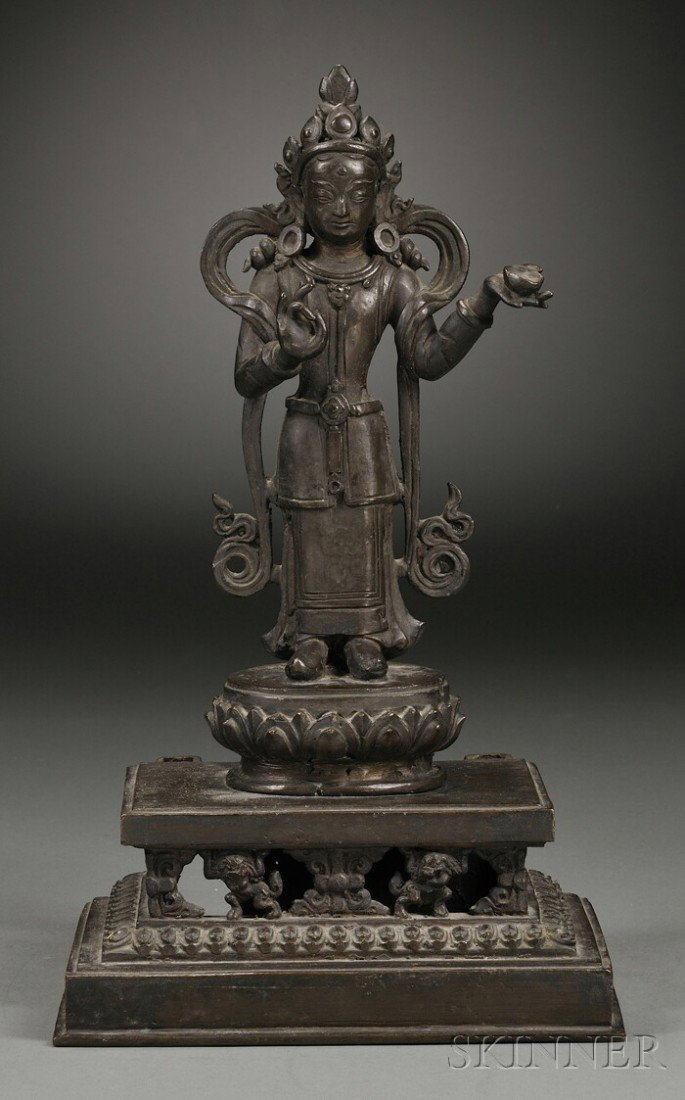 Bronze Image of a Tantric Divinity, Nepal, 19th cen: Bronze Image of a Tantric Divinity, Nepal, 19th century, standing figure on lotus and dais supported by lions, lg. 14 in.