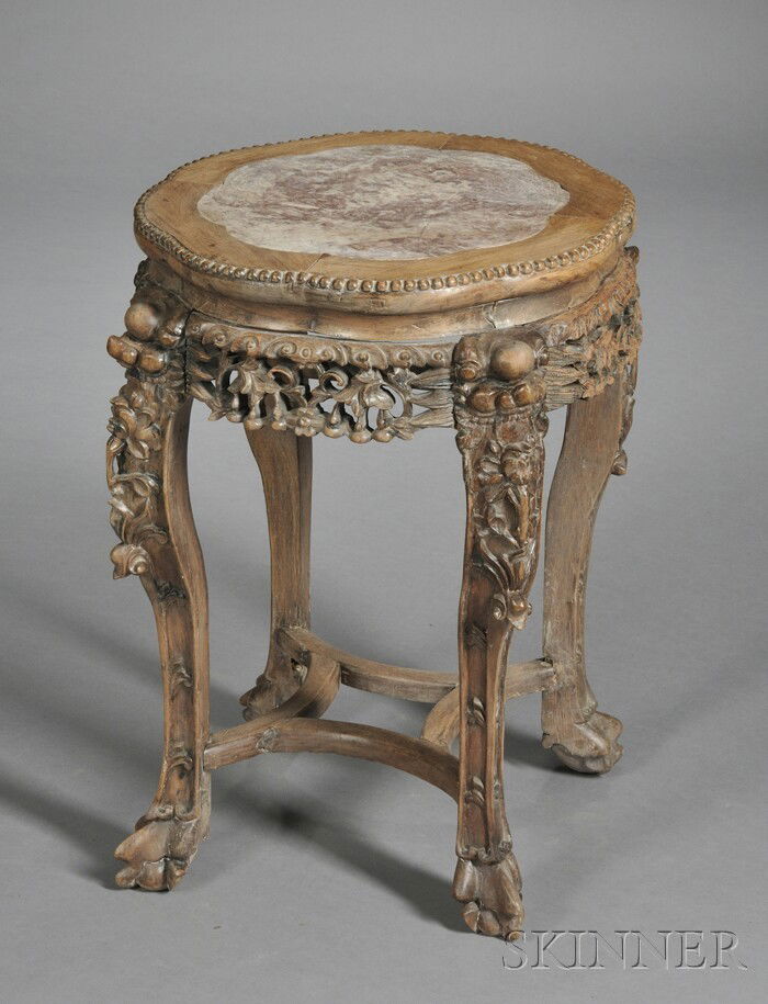 Rosewood Tabouret, China, 19th century, apron carv: Rosewood Tabouret, China, 19th century, apron carved and pierced with leafy scrolls and lotus flowers, feet in the shape of a lion's paw holding a ball, ht. 23 1/2, dia. 16 in.