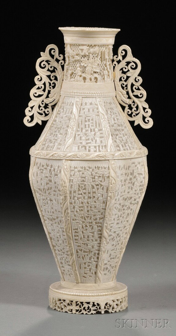 Ivory Vase, China, late 19th century, octagonal, i: Ivory Vase, China, late 19th century, octagonal, intricately carved with Buddhist figures engaging in various activities, the neck flanked by dragon scroll lugs, the foot carved and pierced with flowe
