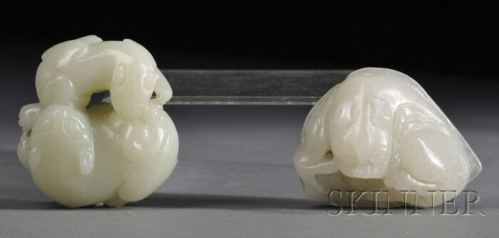 Two Jade Carvings, China, a cat group and a recumb: Two Jade Carvings, China, a cat group and a recumbent foo dog resting on a leaf and holding a leafy sprig in its mouth, the stones of celadon and gray-white color, lg. 1 7/8, 2 1/8 in.