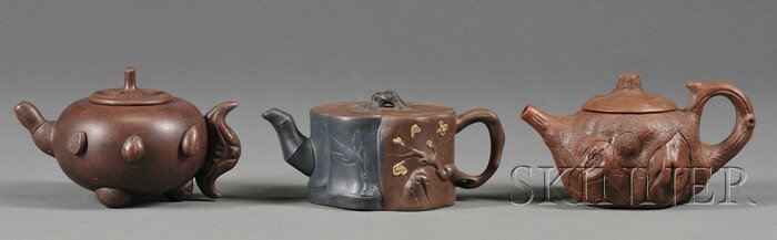 Three Yi Hsing Teapots, China, 20th century, carv: Three Yi Hsing Teapots, China, 20th century, carved in the shape of tree trunks and vegetables.