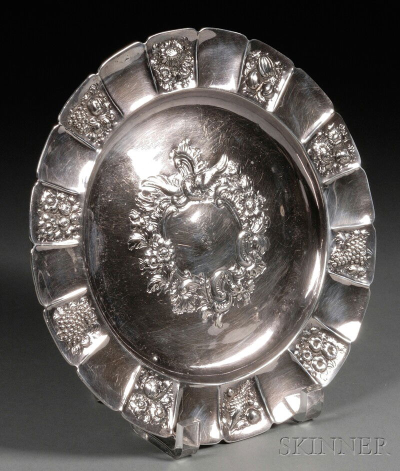 George I Silver Charger, London, 1725, maker's mar: George I Silver Charger, London, 1725, maker's mark rubbed, later chased and embossed to center with cartouche topped by an eagle, the rim with fruit and flower panels, dia. 9 1/2 in., approx. 14.2 tr