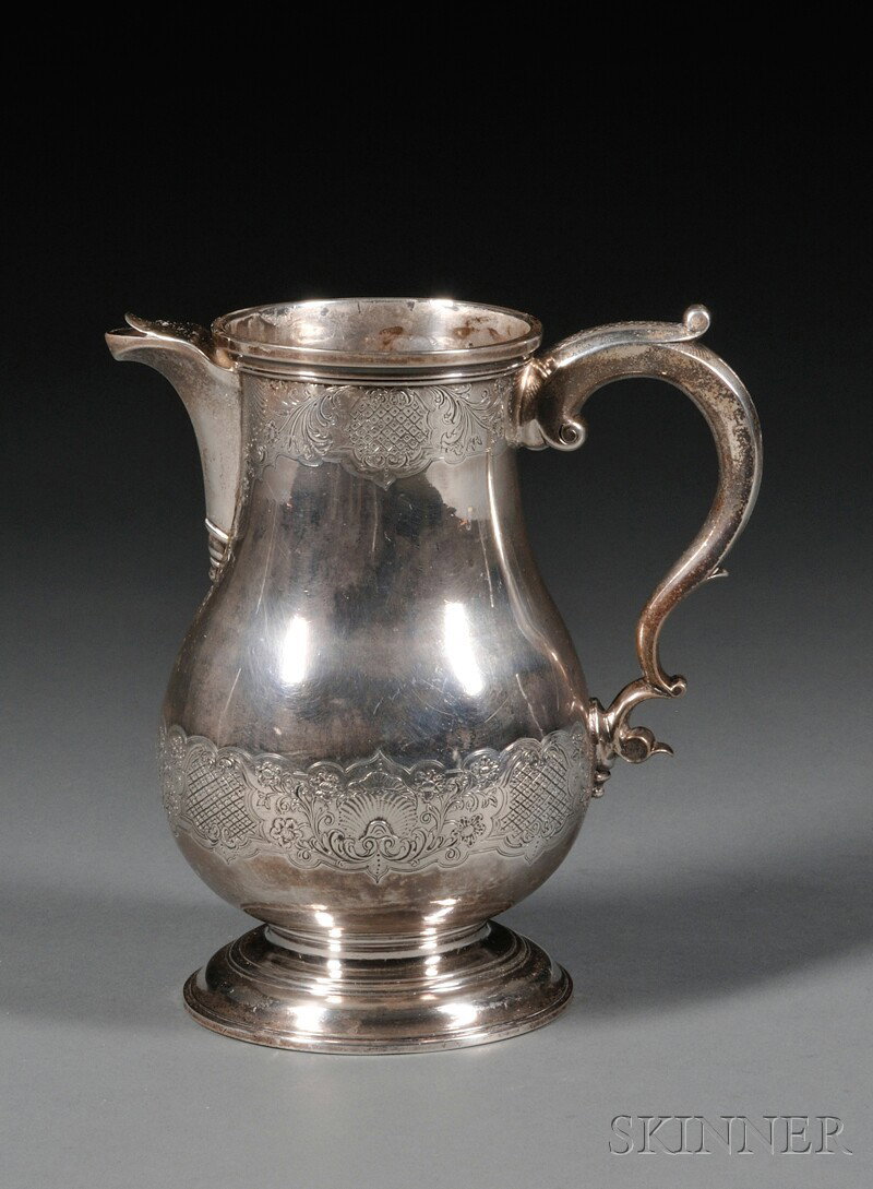 George II Silver Jug, London, 1735, John Jones, m: George II Silver Jug, London, 1735, John Jones, maker, baluster form, with short spout, serpentine handle, and domed foot, engraved at rim and base with band of flowering vines and diapered cartouches