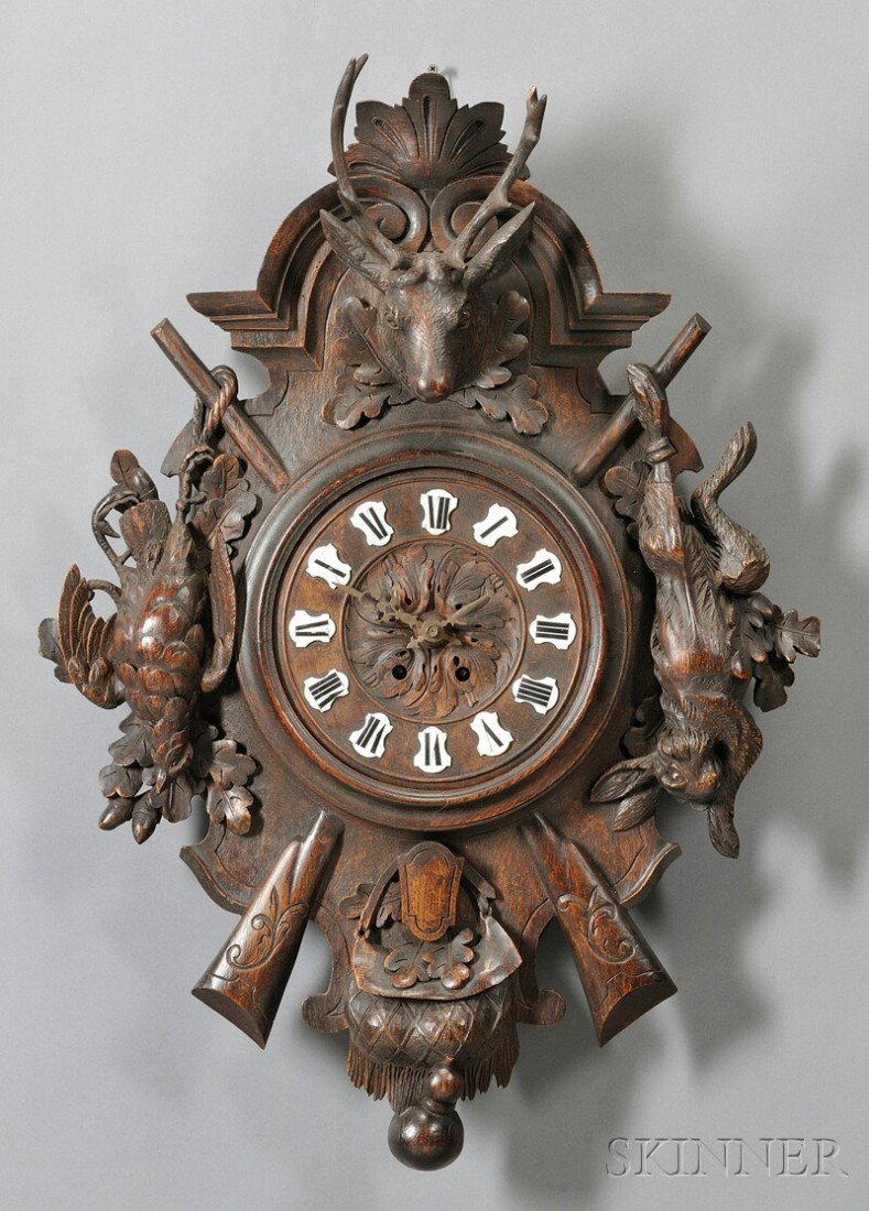 Carved Black Forest Wall Clock, Germany, 19th cent: Carved Black Forest Wall Clock, Germany, 19th century, a deer head centering flanking dead game rabbit and bird, crossed rifles to the base, overall lg. 31 1/2 in.
