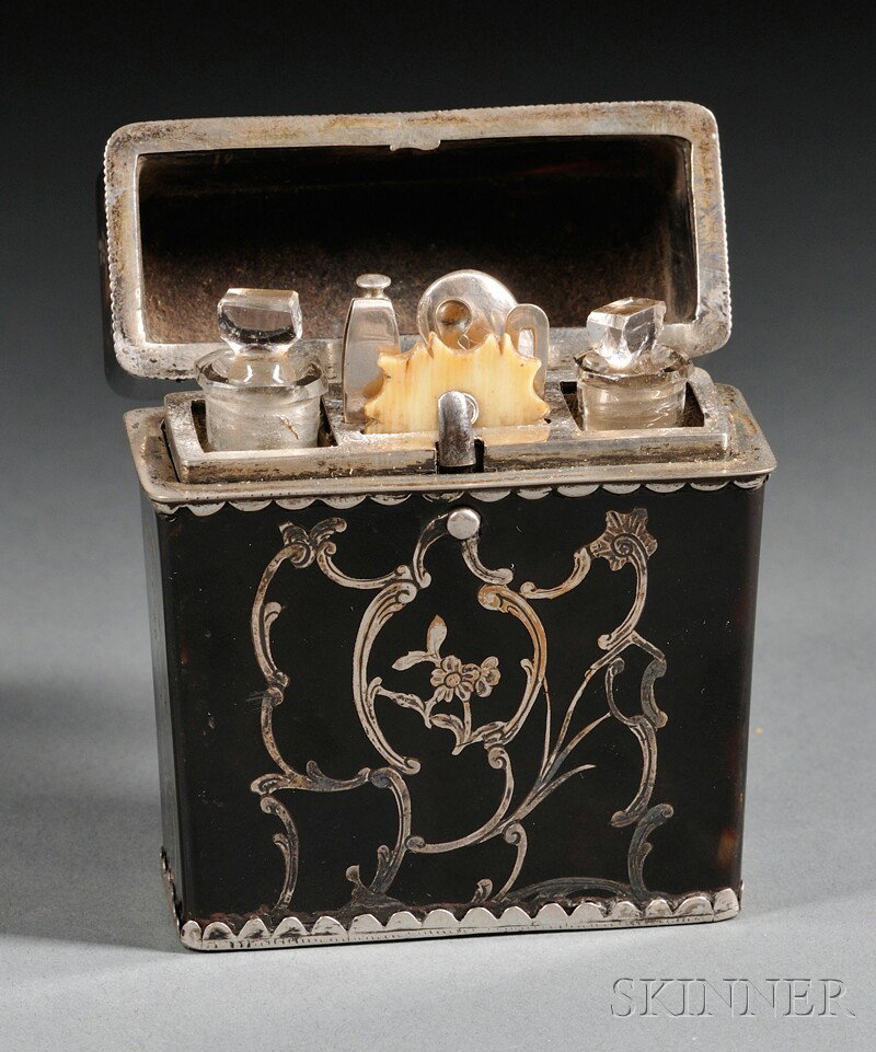 Silver-inlaid Tortoiseshell Travel Set, England, : Silver-inlaid Tortoiseshell Travel Set, England, 19th century, rectangular shape with foliate decoration, the hinged cover revealing a fitted interior with two ink bottles, pen, tweezers, etc., ht. 2 