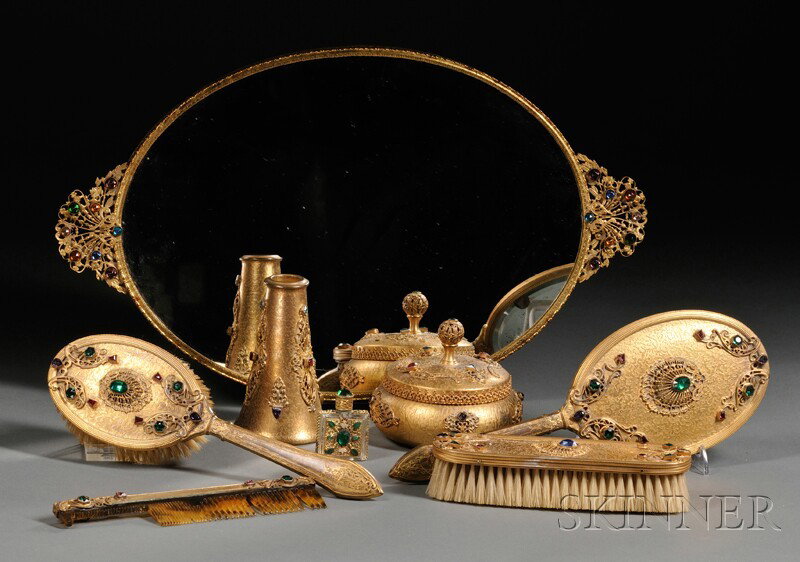 Assembled Nine-piece Jeweled Gilt-metal Dresser S: Assembled Nine-piece Jeweled Gilt-metal Dresser Set, Silvercraft, New York, 20th century, each embellished with colored stones, six matching and including a hand mirror; comb; hair brush; clothes brus