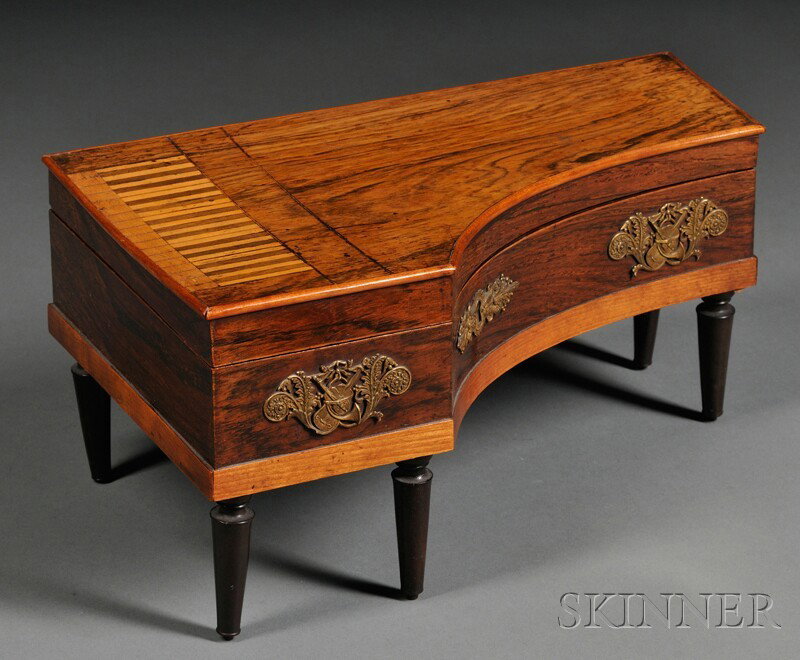 Spinet-shaped Rosewood Necessaire, England, early: Spinet-shaped Rosewood Necessaire, England, early 19th century, gilt-bronze mounted with musical instruments, the hinged lid revealing a mirror top and compartmented base including sewing instruments,
