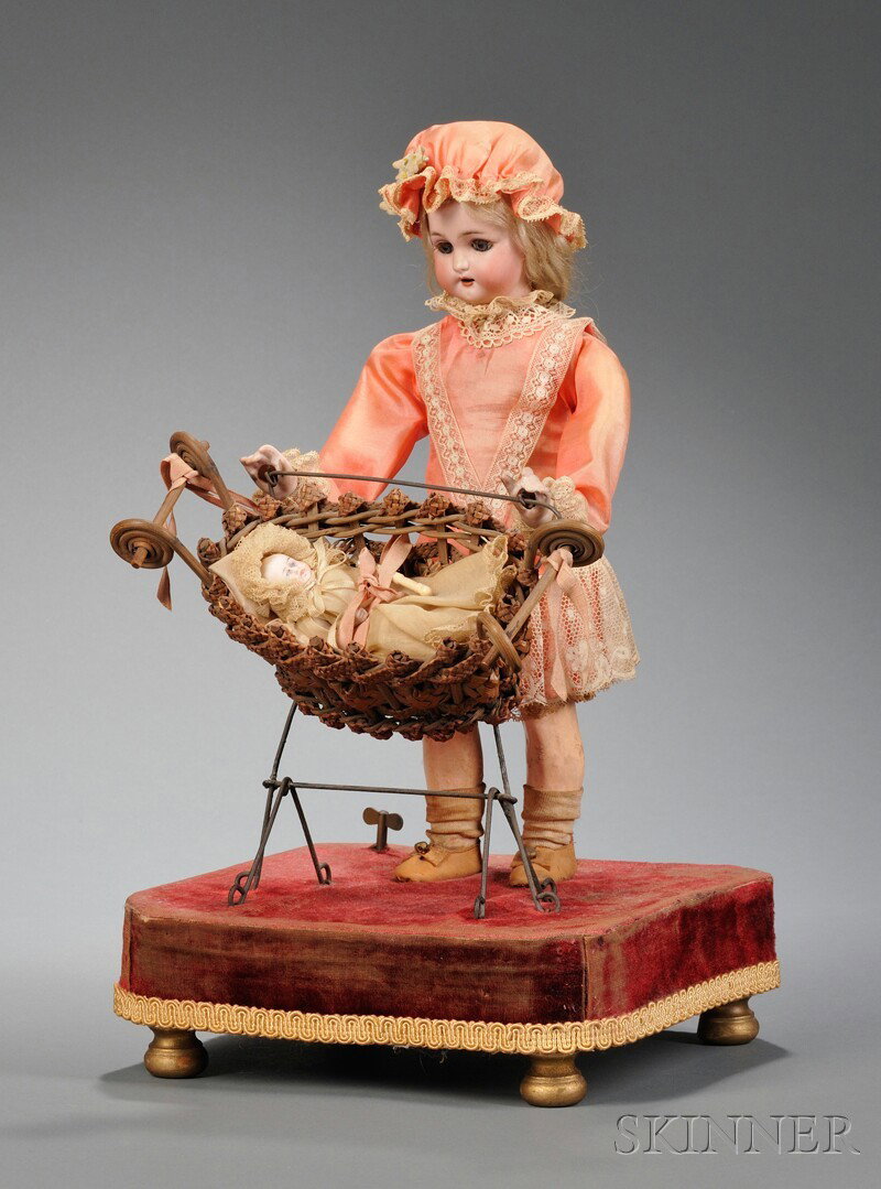 Mechanical Lady Rocking Baby in Cradle, c. 1910, Ro: Mechanical Lady Rocking Baby in Cradle, c. 1910, Roullet & Decamps, Simon Halbig 1300, open mouth bisque head standing figure, ht. 13; rocking basket with all-bisque baby, on velvet-covered platform, 