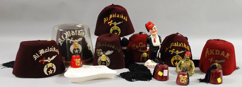 Group of Masonic Shriner's Fez Hats and Other Item: Group of Masonic Shriner's Fez Hats and Other Items, including seven fez hats, ceramic items, and a cast metal ashtray of a seated man wearing a fez.