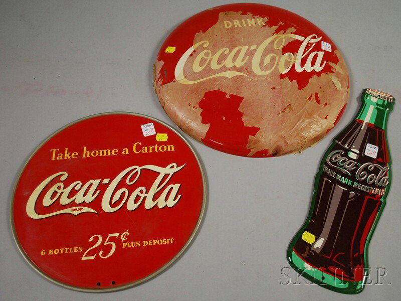 Three Coca-Cola Painted Metal Signs, c. 1940-52, a: Three Coca-Cola Painted Metal Signs, c. 1940-52, a round display, a bottle-form, and a button, (unused), dia. 13, lg. 16 3/4, and dia. 16 in., respectively.