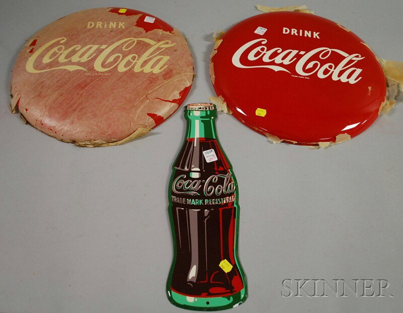Pair of Coca-Cola Painted Tin Button Signs and a C: Pair of Coca-Cola Painted Tin Button Signs and a Coca-Cola Painted Tin Bottle-form Sign, c. 1952, (unused), dia. 16 and lg. 16 3/4 in., respectively.