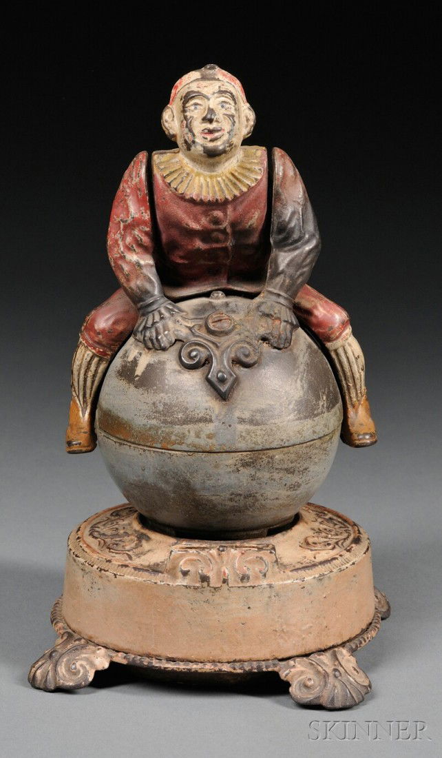 Polychrome Painted Cast Iron Clown on Globe Bank,: Polychrome Painted Cast Iron Clown on Globe Bank, J. & E. Stevens Company, Cromwell, Connecticut, c. 1890, patent information embossed on base, (left arm restored, paint loss and wear), ht. 9 in.