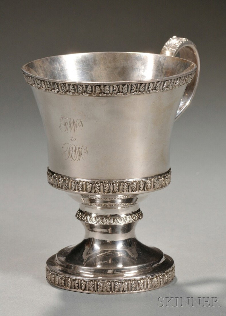 Footed Silver Cup, Robert and William Wilson, Phil: Footed Silver Cup, Robert and William Wilson, Philadelphia, c. 1825, handled cup decorated with bands of anthemion and acanthus, marked "R. & W.W." in a rectangle on base, ht. 5 5/8 in., approx. 10 tr