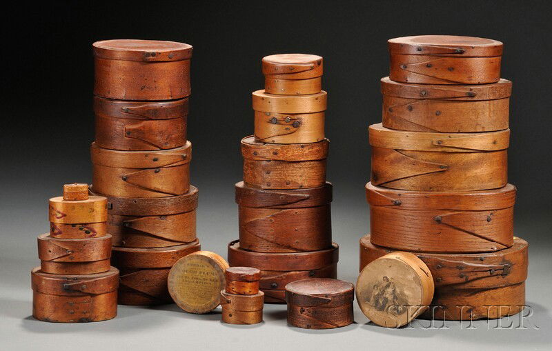 Twenty-four Small Round and Oval Lapped-seam Wood: Twenty-four Small Round and Oval Lapped-seam Wood Storage Boxes, America, 19th century, the boxes can be stacked in graduating formation, two boxes with applied lithograph pictures on the lids, one wi