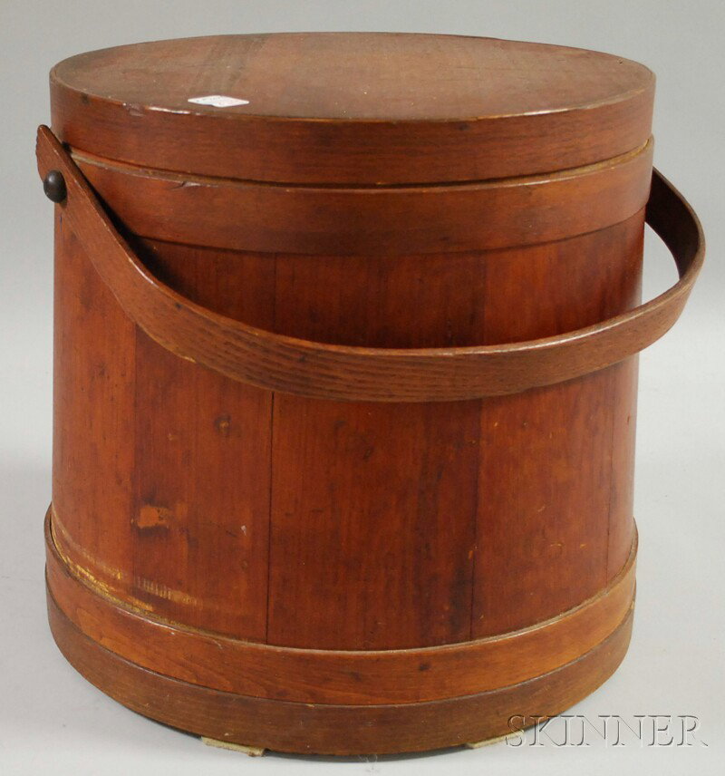 Red-stained Covered Wooden Firkin, America, 19th c: Red-stained Covered Wooden Firkin, America, 19th century, stave and lapped bentwood construction, with swing handle, ht. 14 1/4, base dia. 15 1/2 in.