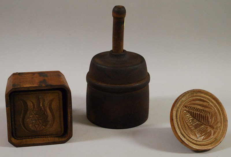 Two Carved Wood Butter Molds and a Butter Stamp, a: Two Carved Wood Butter Molds and a Butter Stamp, a round butter mold carved with two cow figures, a square butter mold with carved pineapple, and a butter stamp with carved pine tree motif, dia. 4-5 1