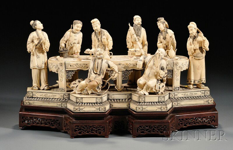 Ivory Carving of a Large Figural Group, China, 19t: Ivory Carving of a Large Figural Group, China, 19th century, a finely carved and incised group of eight officials gathered around a long banquet table set with wine and food, surmounting a double dais