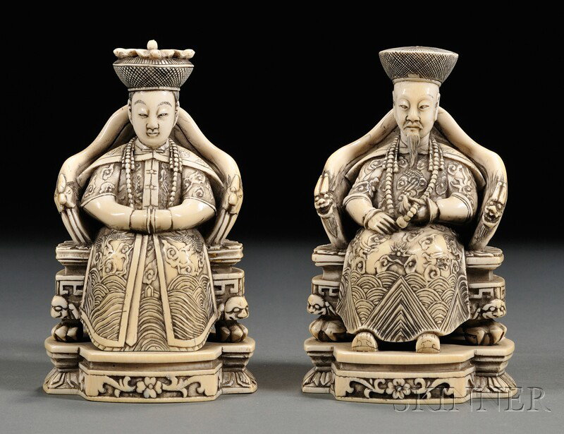Pair of Ivory Carvings, China, finely carved and s: Pair of Ivory Carvings, China, finely carved and stained seated figures of an emperor and empress, robes carved in low relief with dragons and clouds, chairs carved with dragon and lion motifs, ht. 5 
