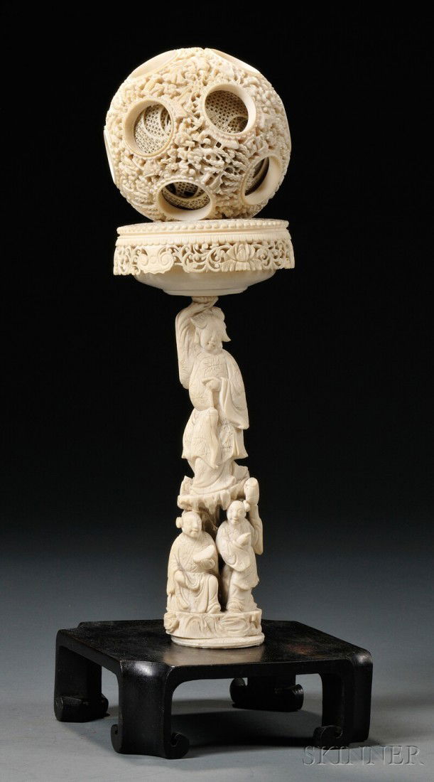 Ivory Puzzle Ball, China, 19th century, the outer: Ivory Puzzle Ball, China, 19th century, the outer sphere carved and pierced with scholars in pavilions, with fourteen circular apertures revealing each concentric sphere within, supported by a stand w